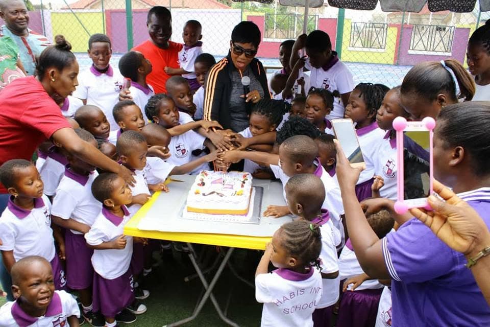 Children gathered around a celebration cake