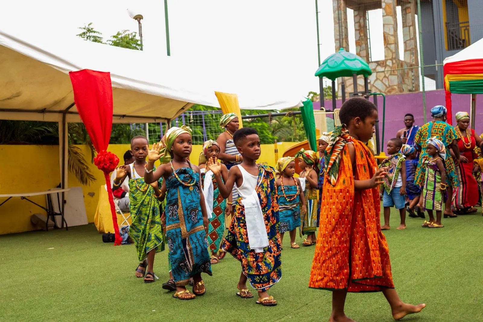 HABIS pupils performing together in colourful patterned clothing
