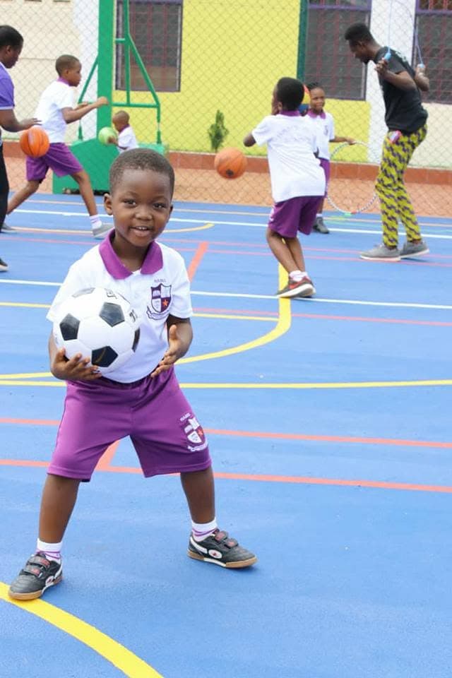 A young pupil holding a football