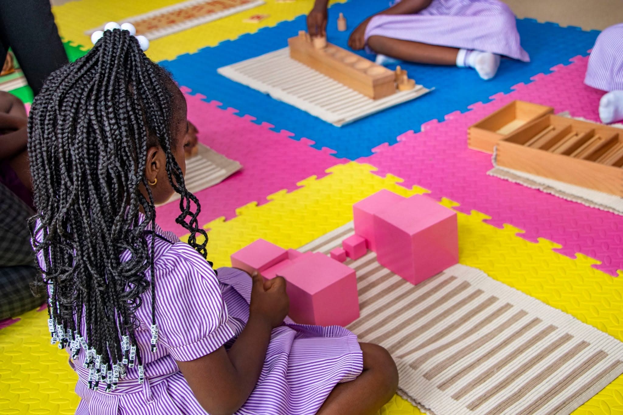 A pre-schooler with Montessori materials