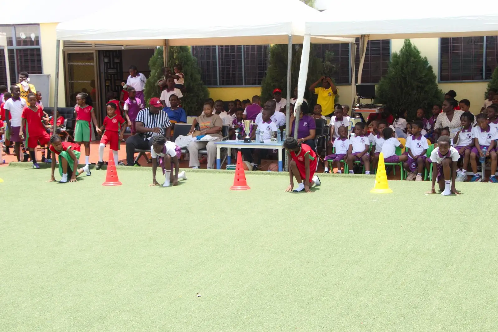 Spectators seated beside cones on the HABIS playing field