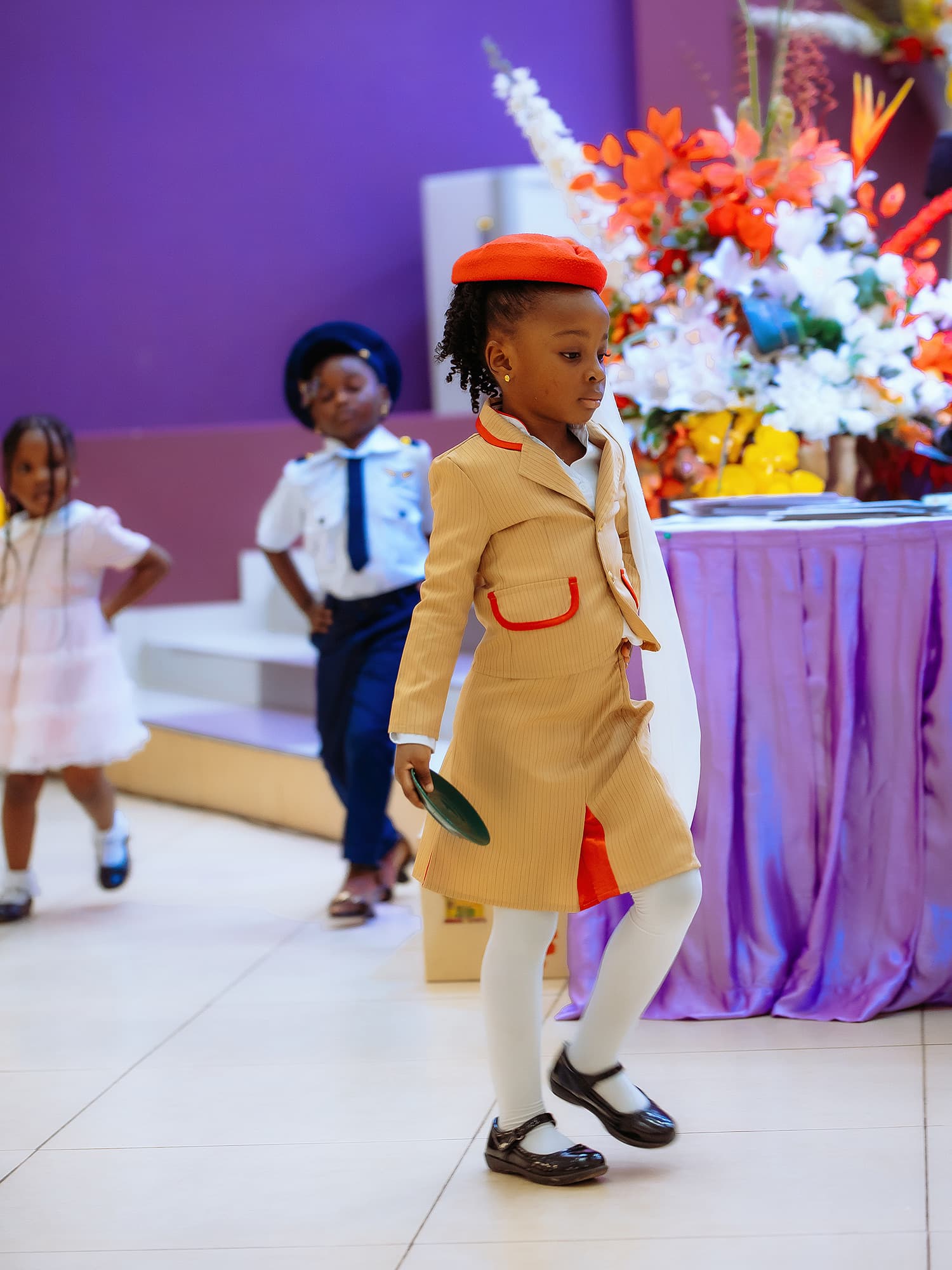 A young HABIS pupil performing in costume during a stage scene