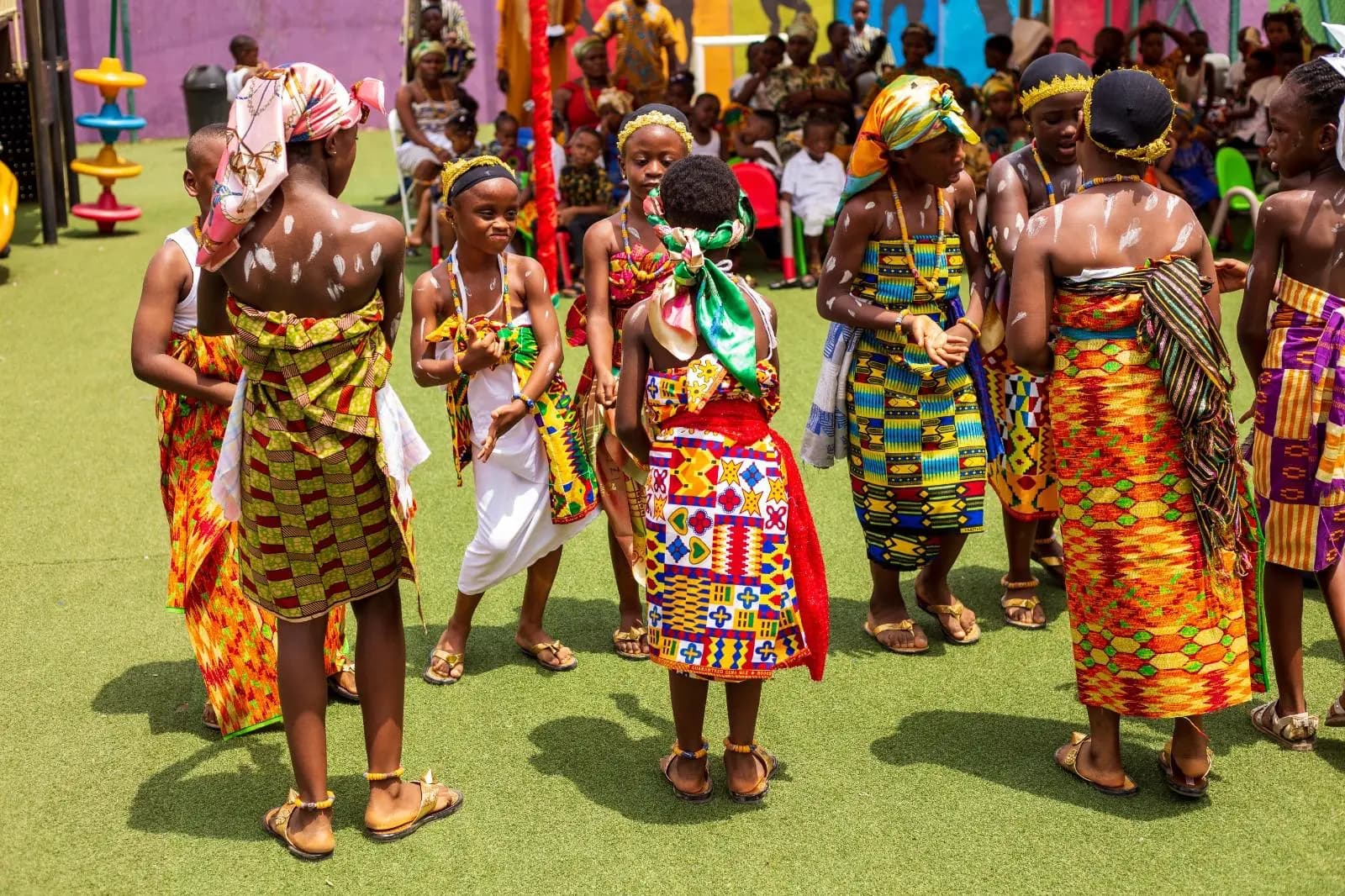 HABIS pupils standing together in colourful traditional outfits and headwear