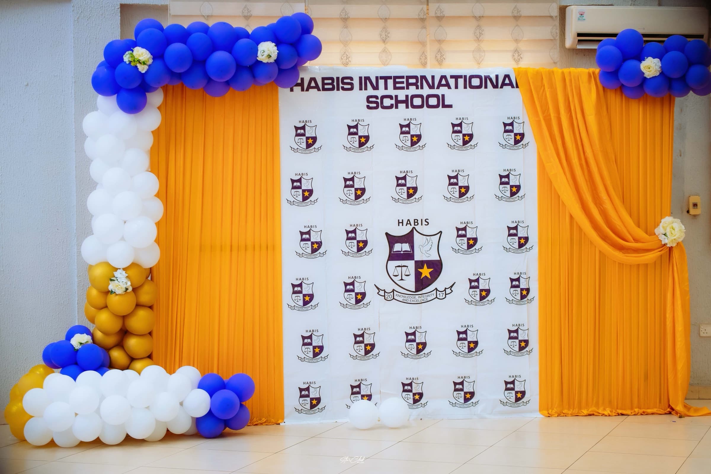 The HABIS graduation and awards ceremony backdrop, decorated in the school colours